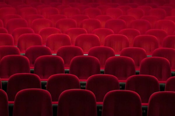 Red theater seats in moody lighting.