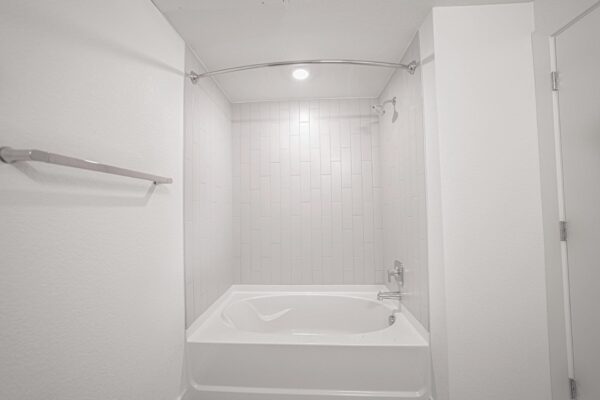 29x apartment bathroom with tiled shower tub.