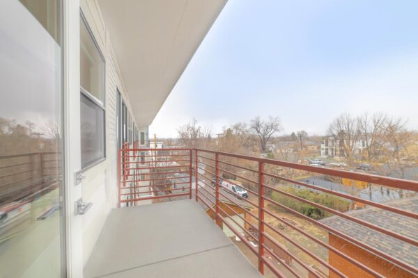 29x apartment balcony with metal railing overlooking Denver.