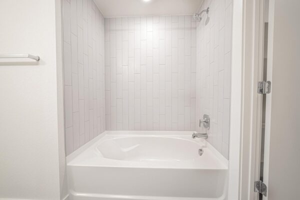 29x apartment bathroom with tiled shower tub.