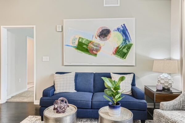 500 Ocean apartment living room with wood style floor, plush seating, and framed artwork.