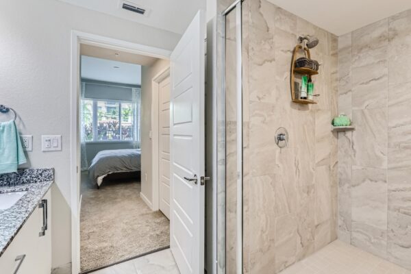 500 Ocean apartment bathroom with tiled shower and tub.