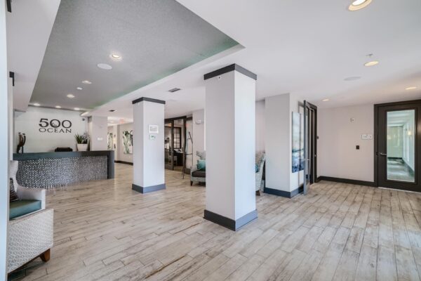500 Ocean apartments entrance with tile floor, plush seating, and leasing desk.
