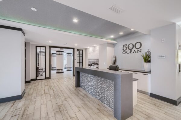 500 Ocean apartments leasing area with elegant desk and large signage.