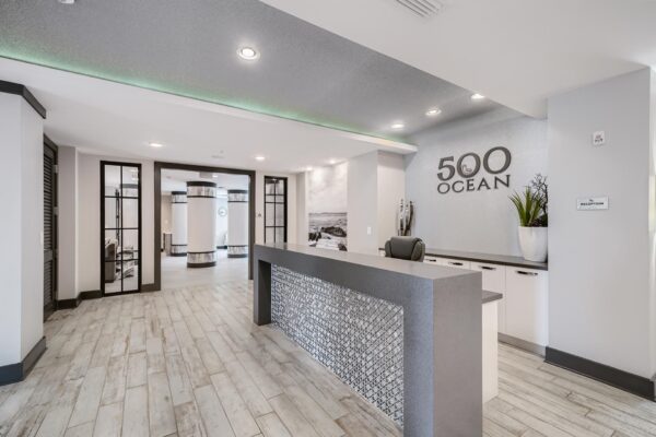 500 Ocean apartments reception area with elegant desk and large signage.
