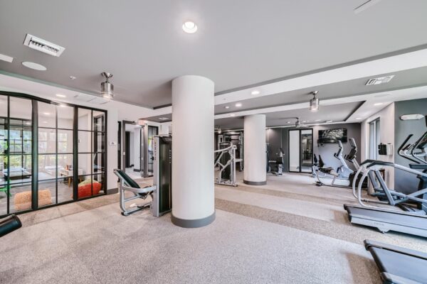 500 Ocean apartments fitness center with cardio machines and weight equipment.