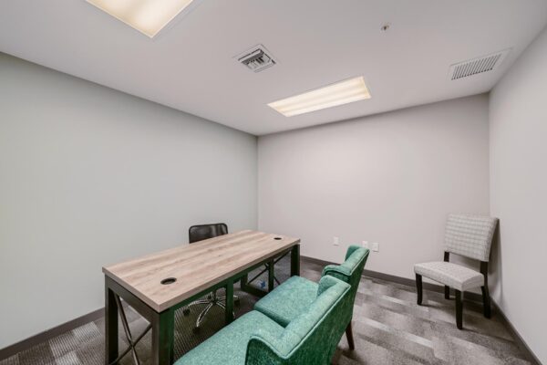 500 Ocean apartments office with desk and plush chairs.