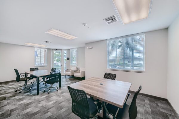 500 Ocean apartments office with conference tables and chairs with sliding tables.