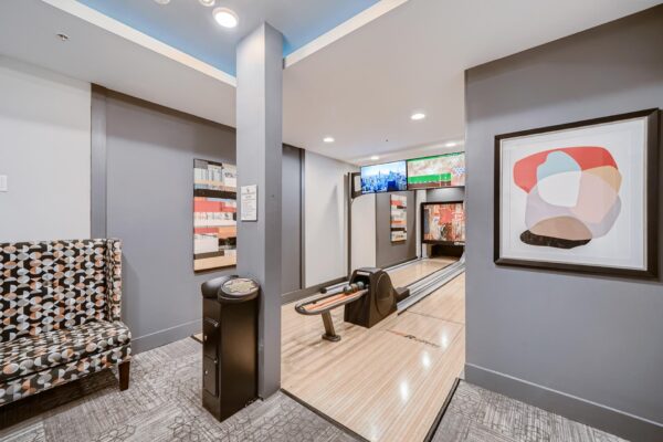 500 Ocean apartments bowling alley with bright artwork and bowling screens.