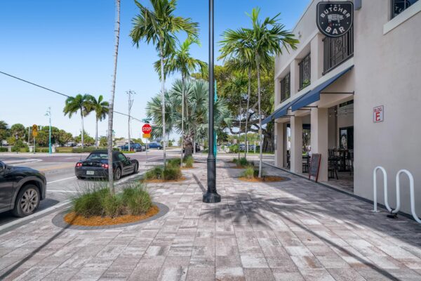 500 Ocean apartments exterior sidewalk with stone paver walkways and restaurant.