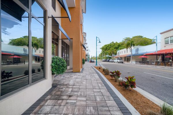 500 Ocean apartments sidewalk with lush landscaping and stone pavers.