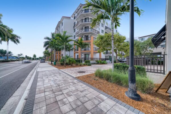 500 Ocean apartments exterior with lush landscaping and stone paver sidewalks.