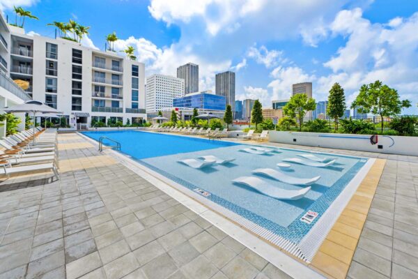 Arte Grand Central pool area with lounge chairs and umbrellas.