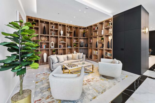 Arte Grand Central residents lounge with plush seating and bookshelves.