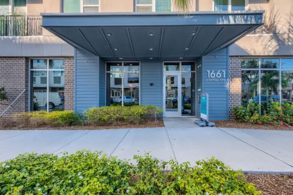 Arte St. Pete apartments entrance with lush landscaping.