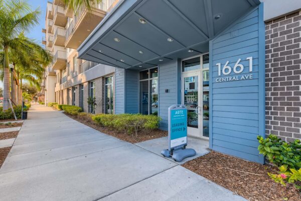 Arte St. Pete apartments entrance with lush landscaping.
