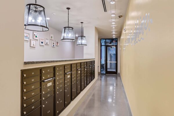 Arte St. Pete apartments mail room with bright lights and mail boxes.