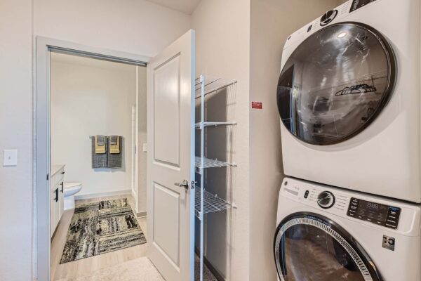 Arte St. Pete apartment laundry closet with stacked washer dryer.