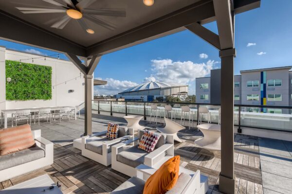 Arte St. Pete apartments rooftop lounge with plush chairs and gazebo.