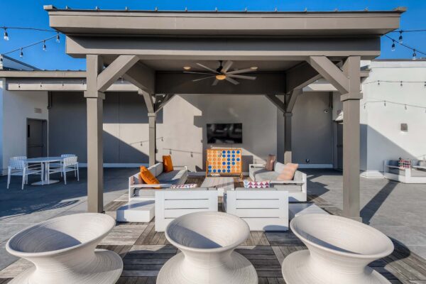 Arte St. Pete apartments rooftop lounge with plush seating and gazebo.