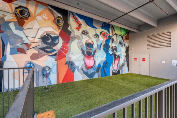 Arte St. Pete apartments dog run with colorful dog mural.