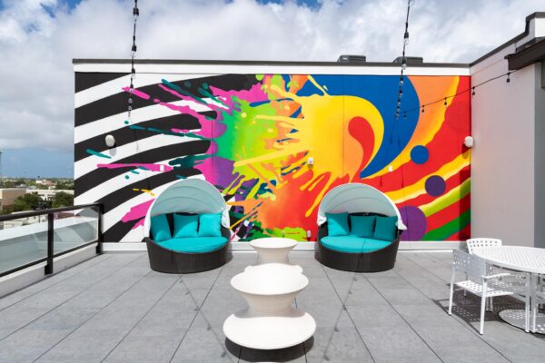 Arte St. Pete apartments rooftop lounge with wall mural