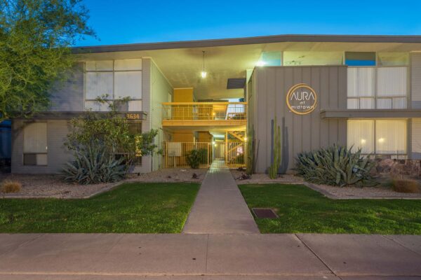 Aura at Midtown apartments with classic mid century stone construction and lush landscaping.