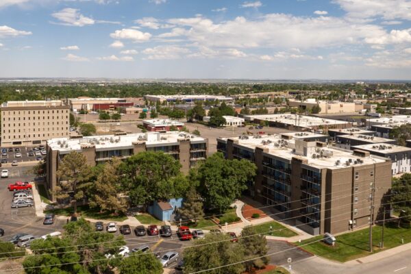 Beacon House apartments with classic brick construction, large balconies, and large trees.