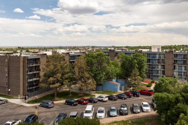 Beacon House apartments with classic brick construction, ample parking, and large trees.