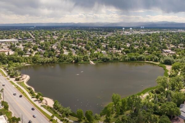 Aerial view of lake surrounded by trees and walking paths near Denver.