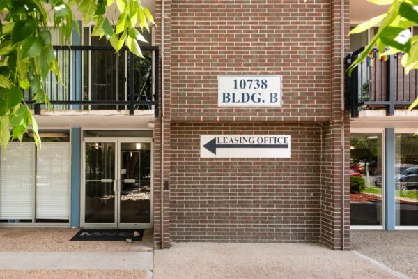 Beacon House apartments entrance with brick construction and glass doors to leasing office.