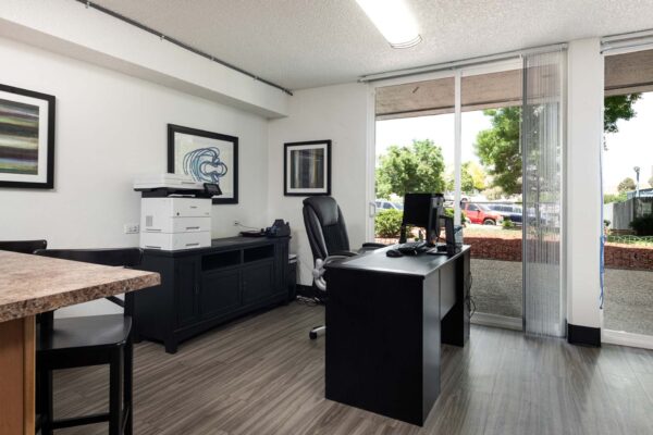 Beacon House apartments leasing office with desk.