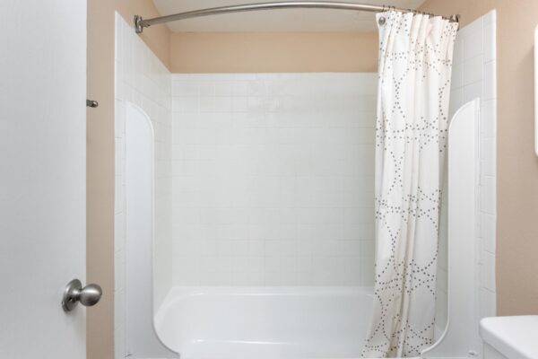 Beacon House apartment bathroom with tiled shower tub.