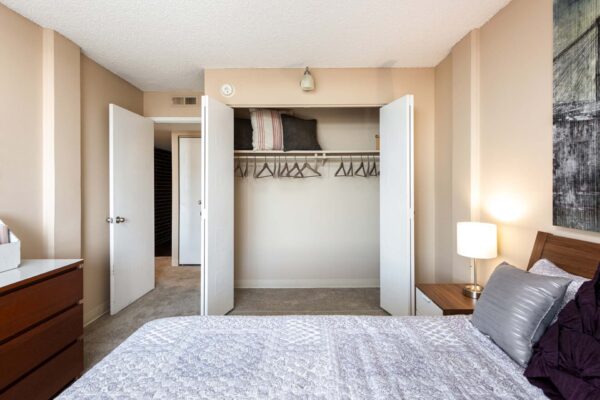 Beacon House apartment bedroom with plush bed and large closet.