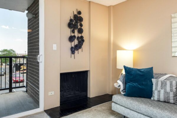 Beacon House apartment living room with plush carpet, fireplace, and couch.