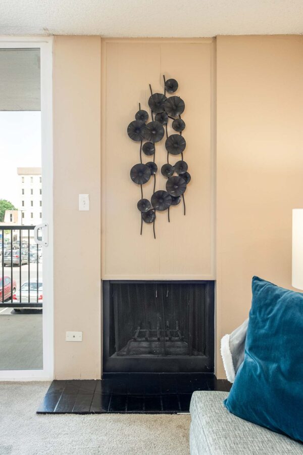 Beacon House apartment living room with plush carpet and fireplace.