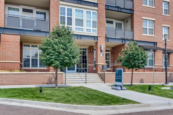 Centre Court apartments with red brick construction and lush landscaping.