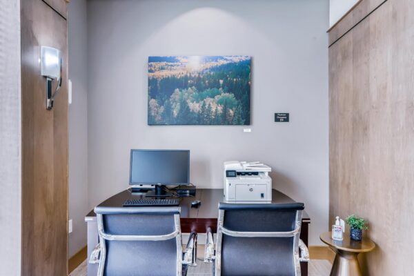 Centre Court apartments business center with computer desk and printer.