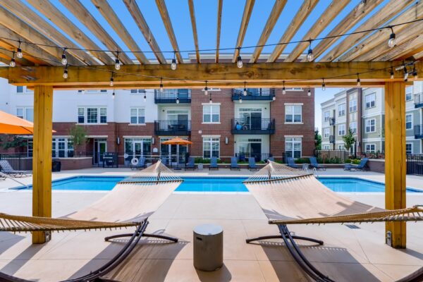 Centre Court apartments pool area with hammocks under pergola.