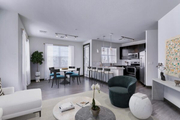 Centre Court apartment living area with wood style floor, modern kitchen, plush seating, and large windows.