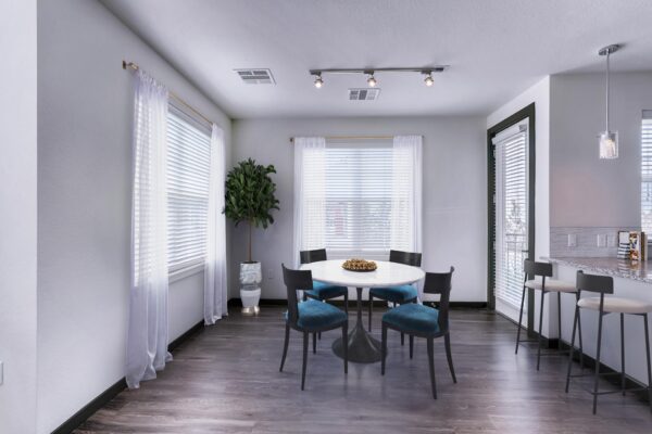 Centre Court apartment dining room with wood style floor, dining table with chairs, and large windows.
