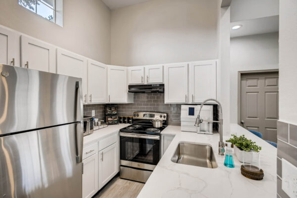 Copper Ridge apartments community kitchen with coffee bar and stainless steel appliances.