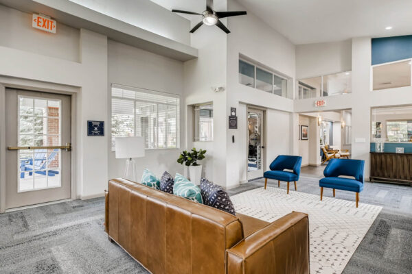 Copper Ridge apartments clubroom with plush seating and vaulted ceilings.