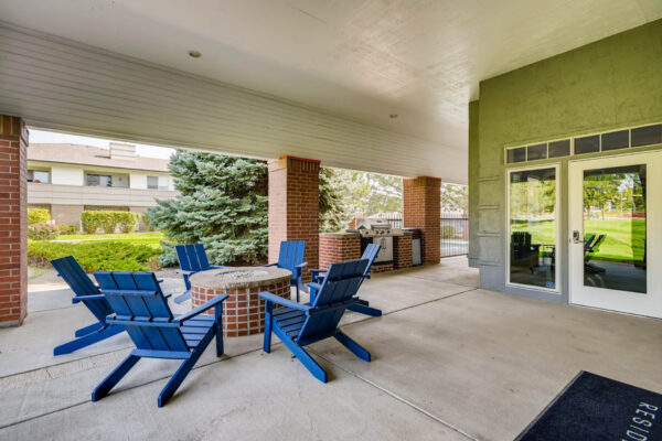 Copper Ridge apartments outdoor lounge with fire pit, lounge chairs, and BBQ grill.