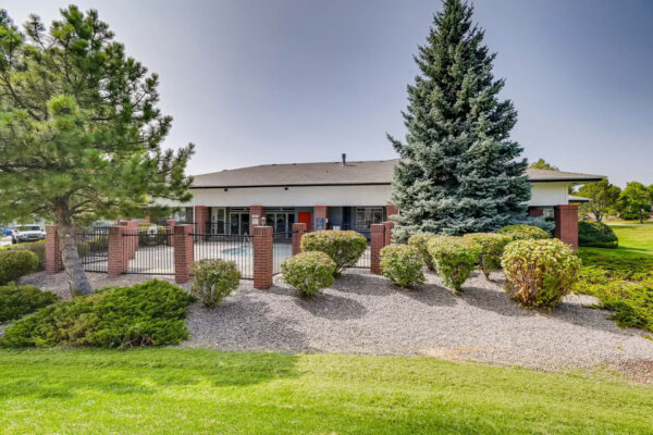 Copper Ridge apartments with lush landscaping and tall pine trees.