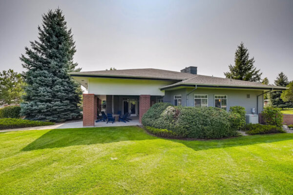 Copper Ridge apartments with lush landscaping and tall pine trees.