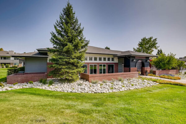 Copper Ridge apartments with lush landscaping and tall pine trees.