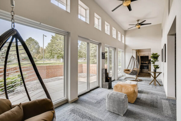Copper Ridge apartments clubroom lounge with comfortable seating and large windows.