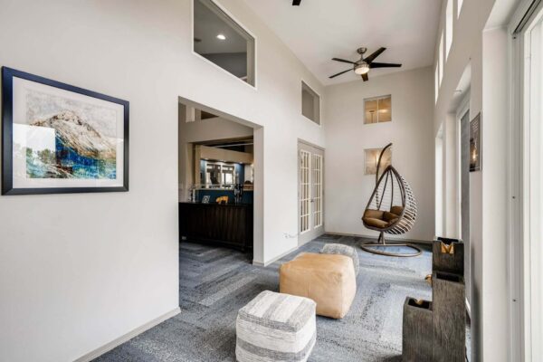 Copper Ridge apartments clubroom lounge with comfortable seating and large windows.