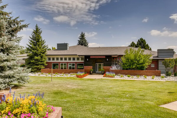 Copper Ridge apartments with lush landscaping and tall pine trees.